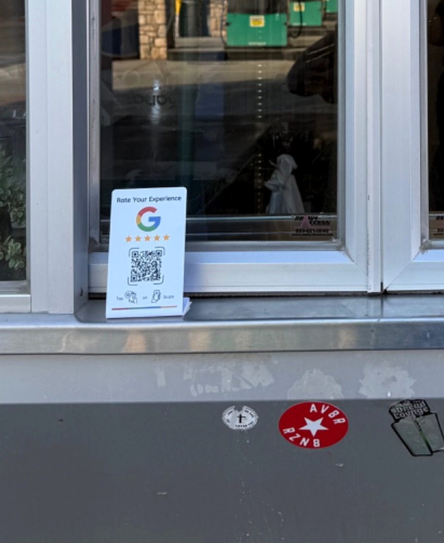 Close-up of an NFC review display installed at a restaurant
